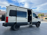 Spacious, off-road Sprinter camper van. Side door open, revealing interior. Perfect for an RV rental adventure.