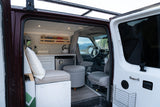 Spacious RV rental interior with kitchen, cozy seating, and a view of mountains. Perfect for your next adventure!