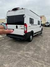 This white Winnebago Solis camper van, ready for your RV rental adventure, is parked on a spacious lot.