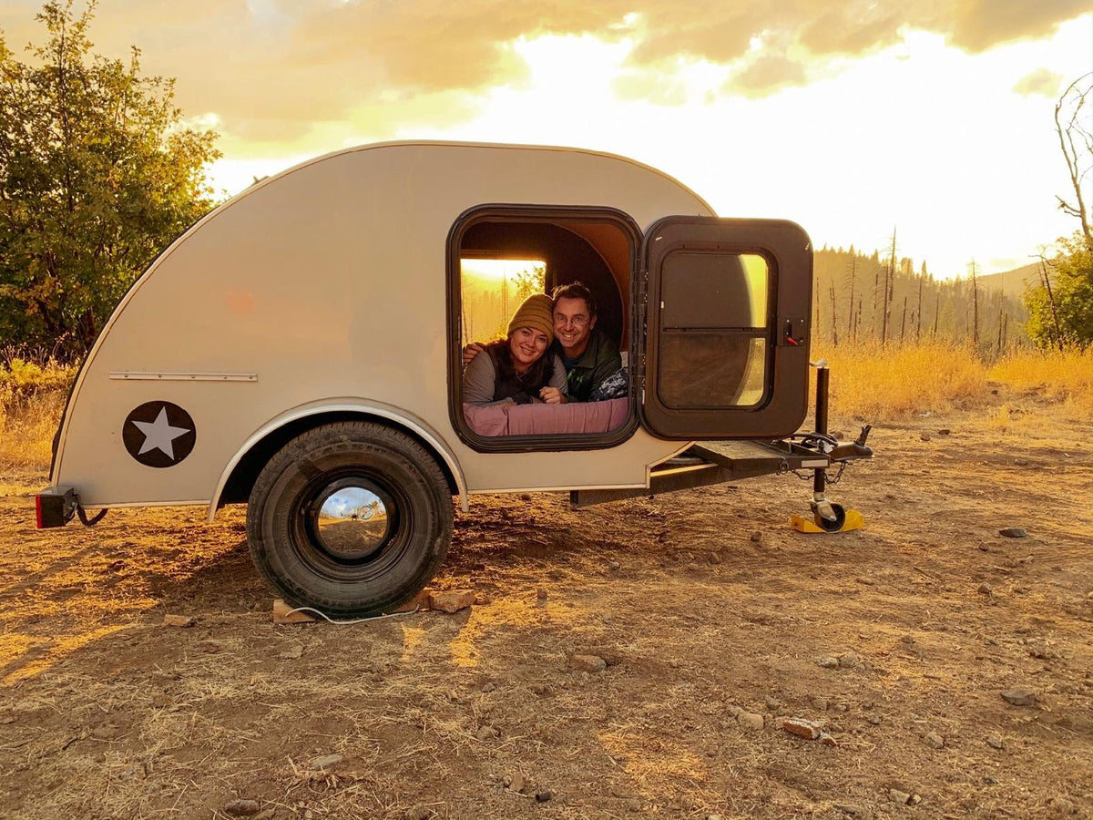  and a rear door with a screen.|Cozy rv rental interior: bed
