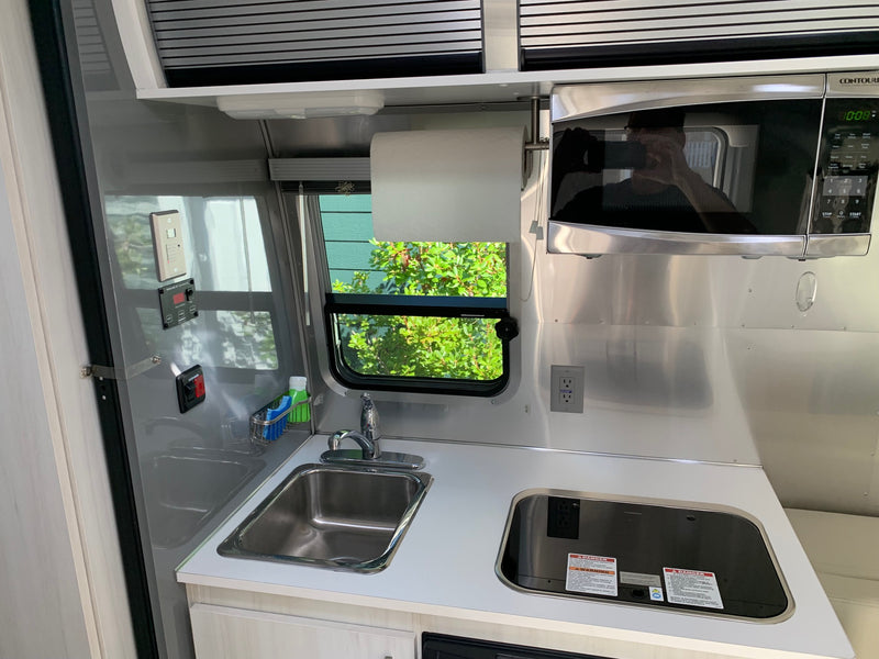  is parked with its door open for adventure.|Airstream Bambi travel trailer — photo 3