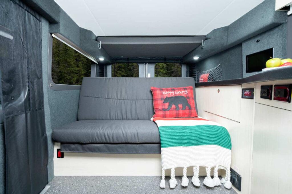  and seating.|Modern rv rental interior: compact kitchen with sink — photo 6