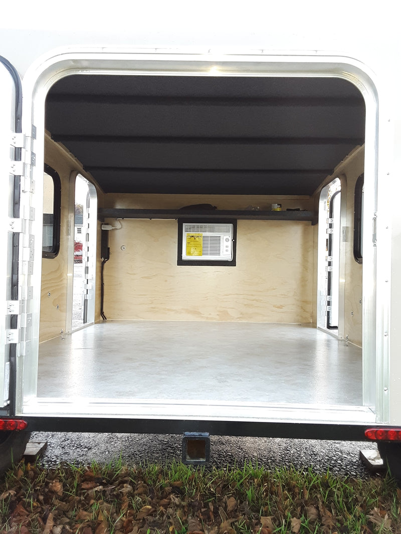  and seating. A small control panel is visible.|RV rental interior showing wall-mounted air conditioner — photo 4