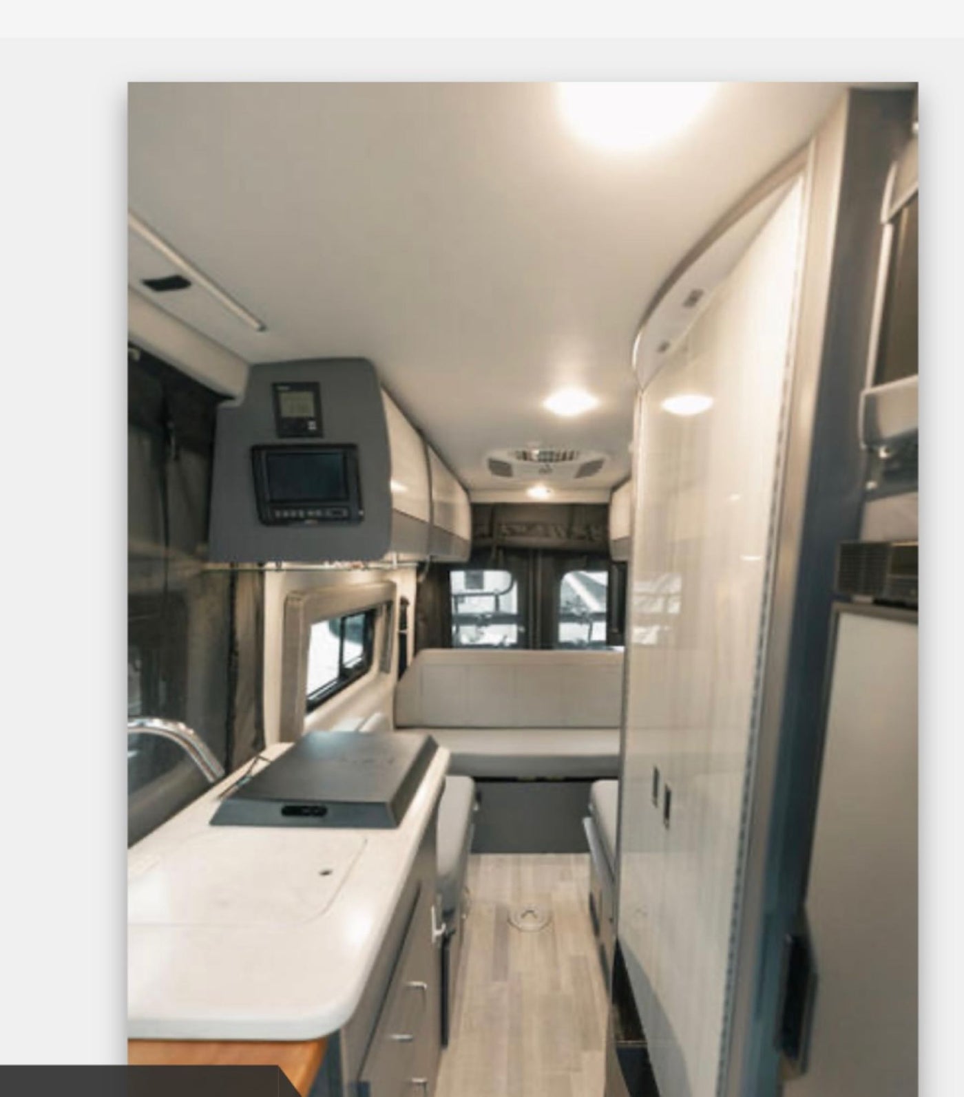  with a bike rack and rooftop AC unit.|This rv rental features a well-equipped kitchenette: sink — photo 8