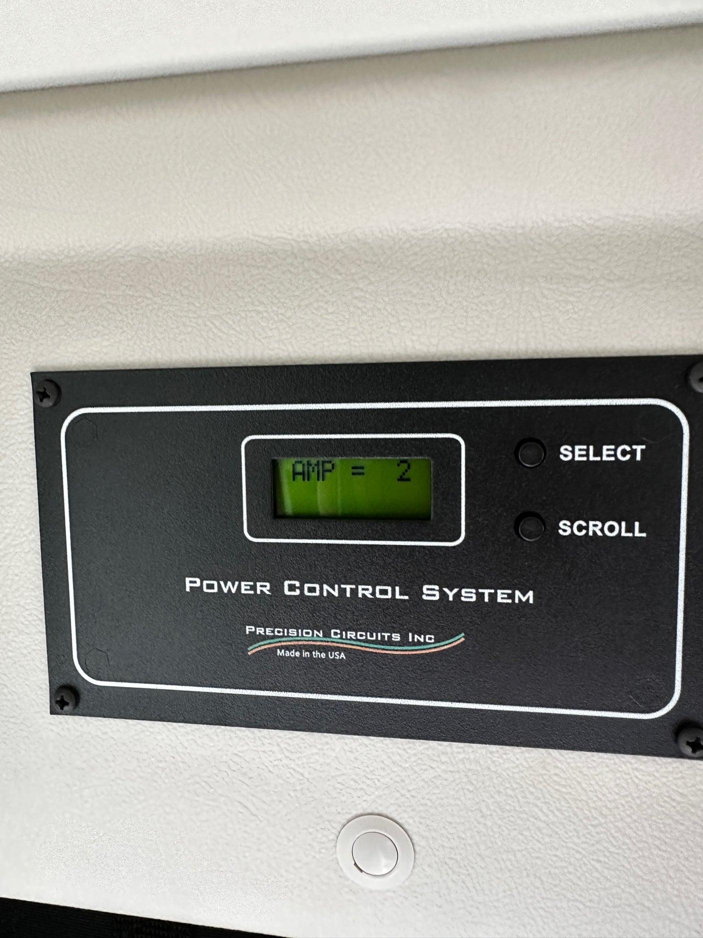 RV rental power control panel. The display shows 'AMP = 2', with 'Select' and 'Scroll' buttons.