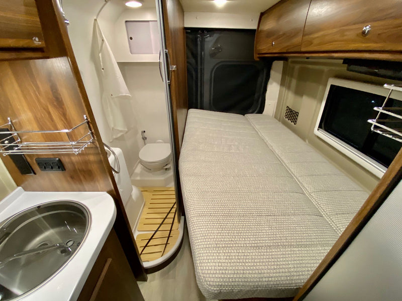  perfect for comfortable road trips.|Spacious RV rental interior with white leather seating — photo 3