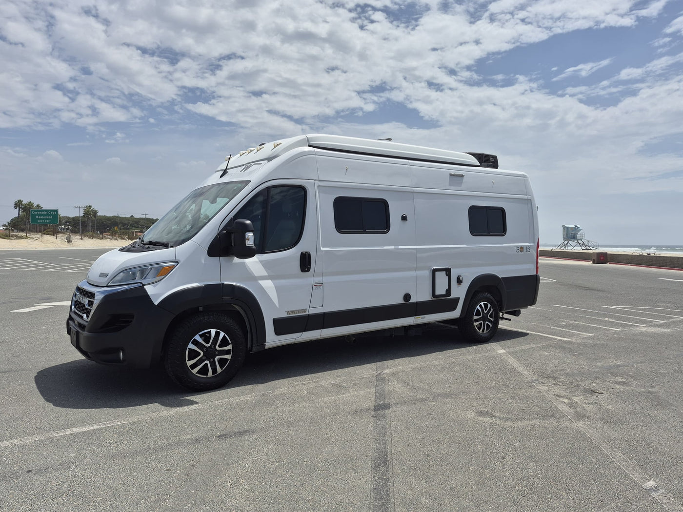  is parked in a spacious beachside lot under a bright — photo 4