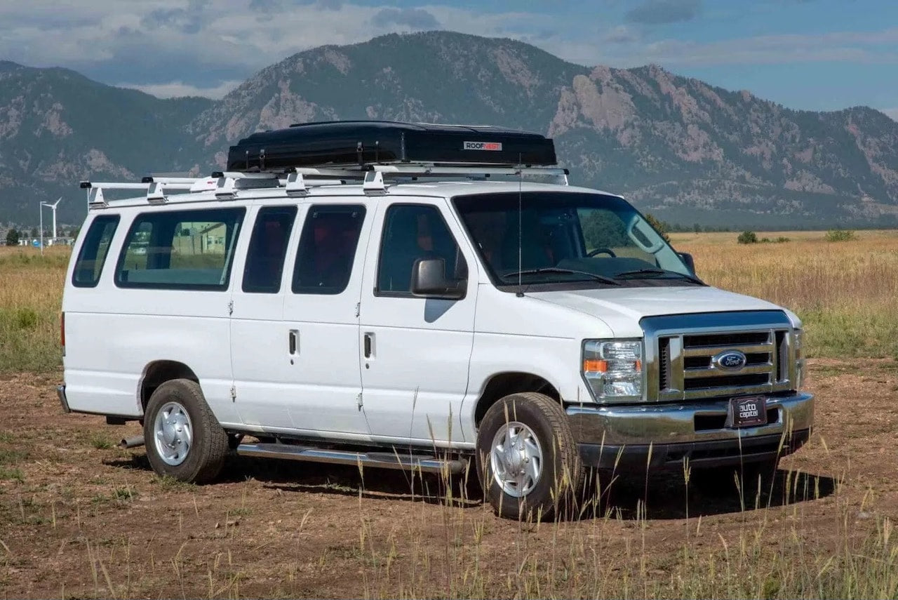  perfect for your next RV rental adventure.|White Ford RV rental van with a hardshell rooftop tent — photo 2