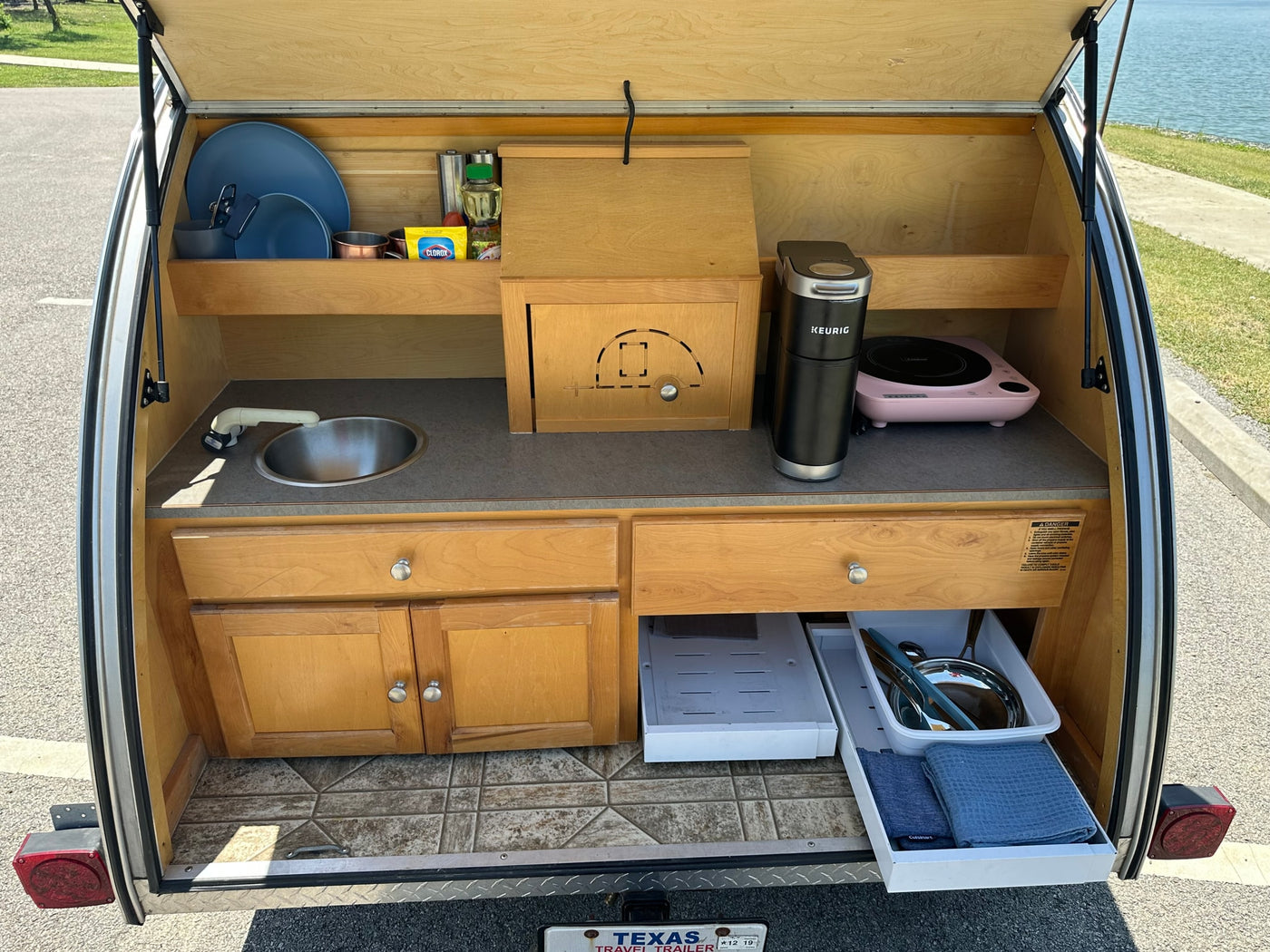 perfect for lakeside camping adventures.|Compact camper kitchen for RV rental adventures — photo 2