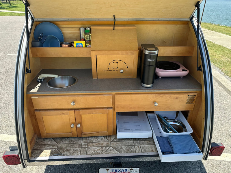  perfect for lakeside camping adventures.|Compact camper kitchen for RV rental adventures — photo 2