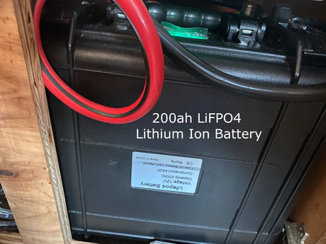 Essential for an rv rental, this 200Ah LiFePO4 lithium battery provides reliable off-grid power inside a wooden enclosure.