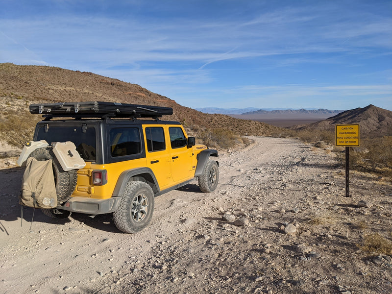 Yellow Jeep Rubicon with a rooftop tent at sunset. Ideal rv rental for scenic overlanding and camping.|Bright yellow Jeep Rubicon with rooftop tent on a dirt road. Explore off-road camping with this adventure RV rental.|Yellow Jeep Wrangler with an open rooftop tent — photo 19