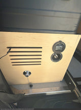 Utility panel inside an rv rental, showing a "Not Potable" water hookup, ventilation slats, and a drain plug.
