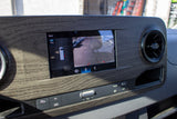 RV rental's dashboard displays the rear camera view for parking. The screen shows parking lines and a top-down vehicle icon.
