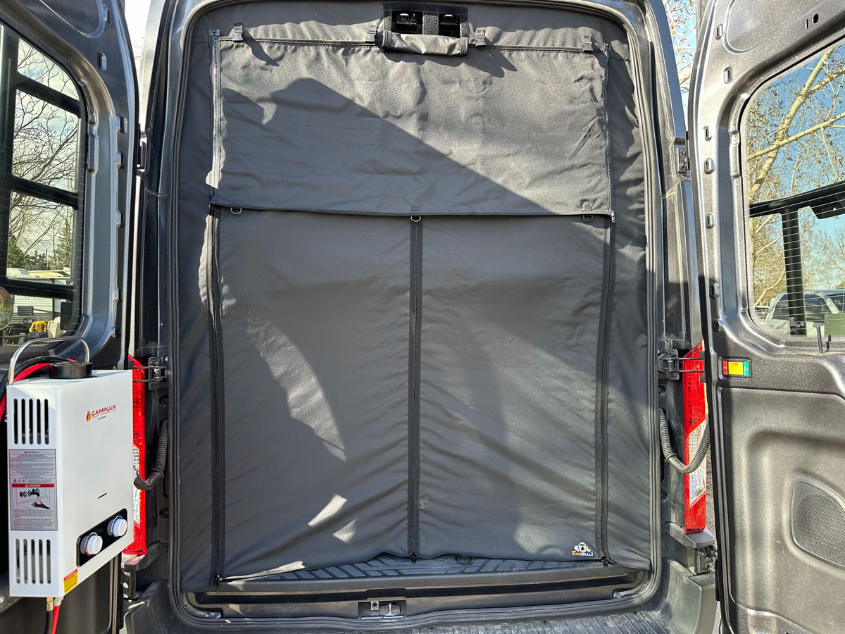 RV rental rear doors open, showing a black privacy/insulation screen, and an external Camplux water heater on the left. — photo 15