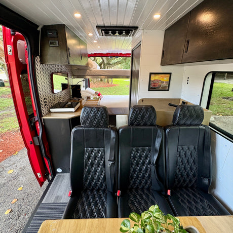 Experience comfort in this RV rental's custom interior: seating for three, a kitchen, and a sleeping area. Ideal for camping & travel.