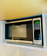 Built-in Black+Decker microwave, a convenient kitchen appliance found in an RV rental kitchen setup.