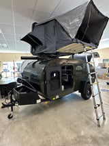 Dark green MOD BUG teardrop trailer with REC PRO rooftop tent, ideal for RV rental adventures.