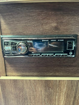 An RV rental's Boss 611UAB stereo system provides Bluetooth, USB, and AUX connectivity for travel entertainment.