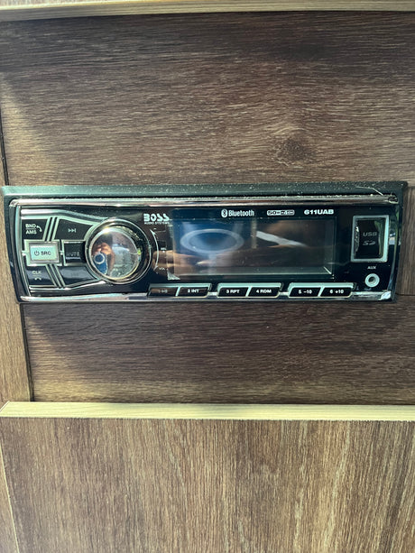 An RV rental's Boss 611UAB stereo system provides Bluetooth, USB, and AUX connectivity for travel entertainment.