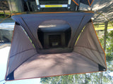 Inside a cozy, open rooftop tent, revealing a mattress and ample space. Perfect for RV rental camping and outdoor adventures.