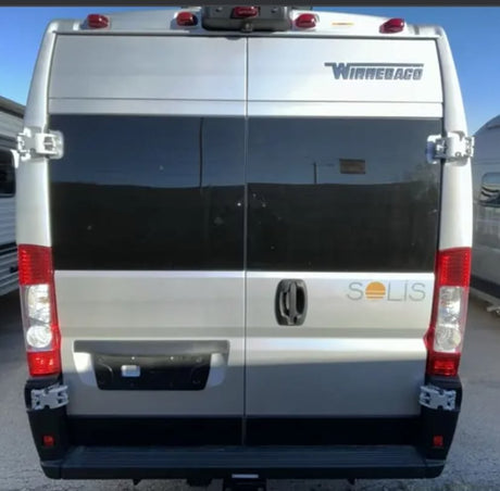 Rear view of a silver Winnebago Solis camper van. Perfect for your next rv rental, featuring tinted windows.