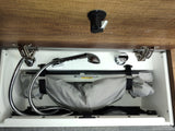 RV rental's hidden shower system, showing faucet, hose, and folded basin neatly stowed in a compact cabinet.