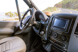 Driver's view from an RV rental: cockpit with detailed dashboard, steering wheel, and scenic coastal road ahead for adventure.