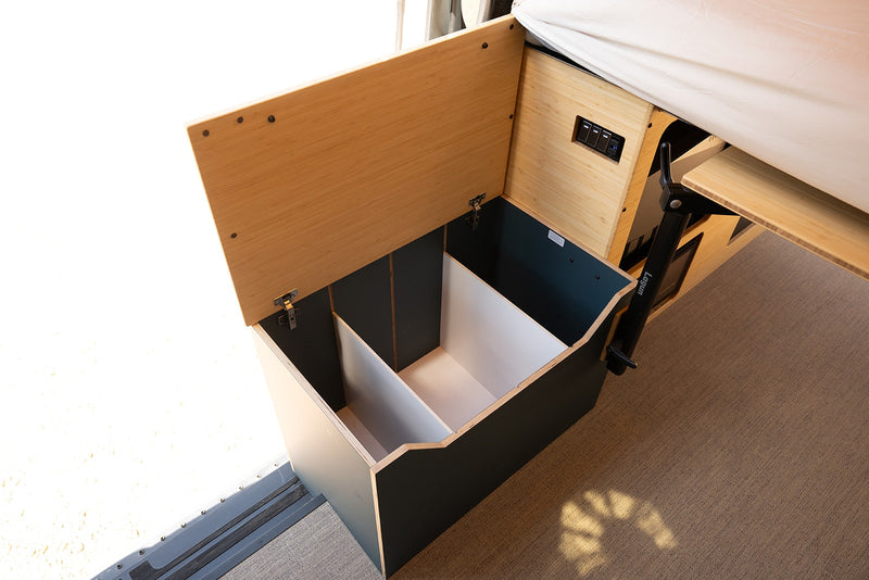 See efficient storage in this RV rental: an open-lid box with interior dividers and a pull-out table arm. — photo 10