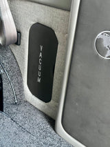 RV rental interior features a 'VACUUM' panel for the integrated system, alongside a seatbelt and grey interior materials.