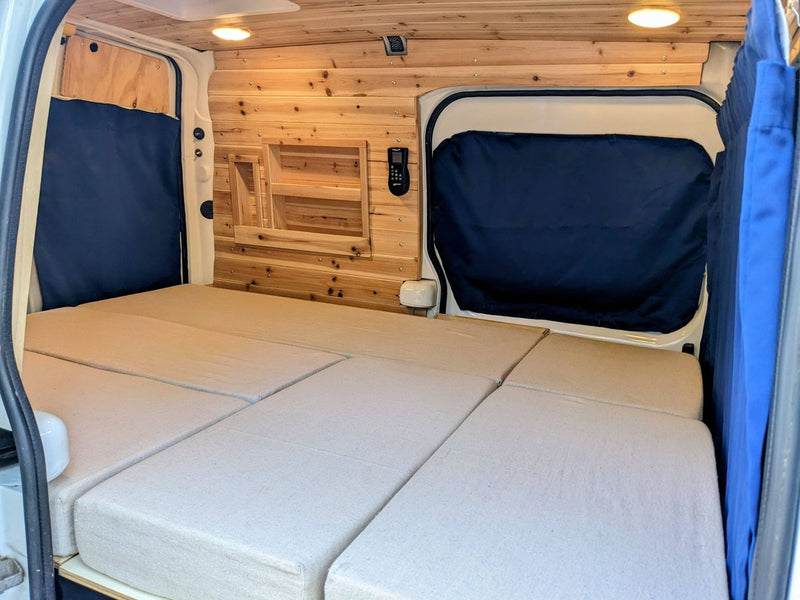  and a lit control panel. Cozy mobile living!|RV rental interior: Custom camper van with pull-out storage — photo 14
