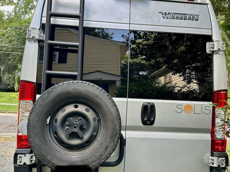  parked outdoors with a sunshade & leveling blocks.|This rv rental camper van — photo 5