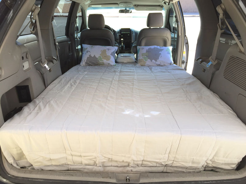  a full bed and pillows for camping. Ideal for an RV rental or road trip comfort.|Rooftop tent on minivan — photo 8