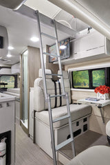 Modern rv rental interior: features ladder to upper bunk, dinette, TV, kitchen, and shower for ultimate camper comfort.