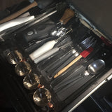 RV rental kitchen drawer: neatly organized with flatware, cooking utensils, measuring cups, and a Mr. Coffee frother.