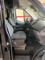 Interior view of a black RV rental van's front cabin, showing grey driver and passenger seats, dashboard, and steering wheel.