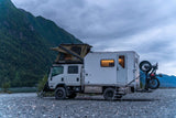 The rig camped along a river valley