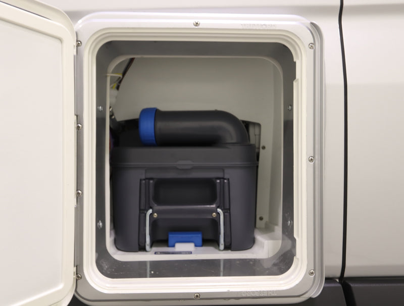 RV rental external compartment showing a dark gray cassette toilet waste tank with a blue cap. Essential for camper sanitation. — photo 15