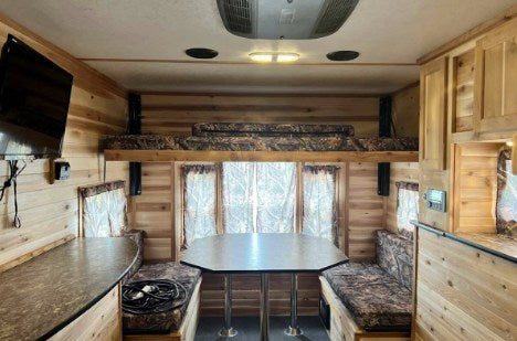  a unique RV rental option for outdoor adventure. This versatile trailer features multiple windows.|RV rental interior: light wood walls