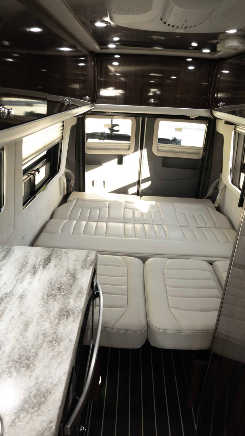  offering comfort and connectivity.|Inside a sleek RV rental: modern kitchen with stone-look countertop — photo 15