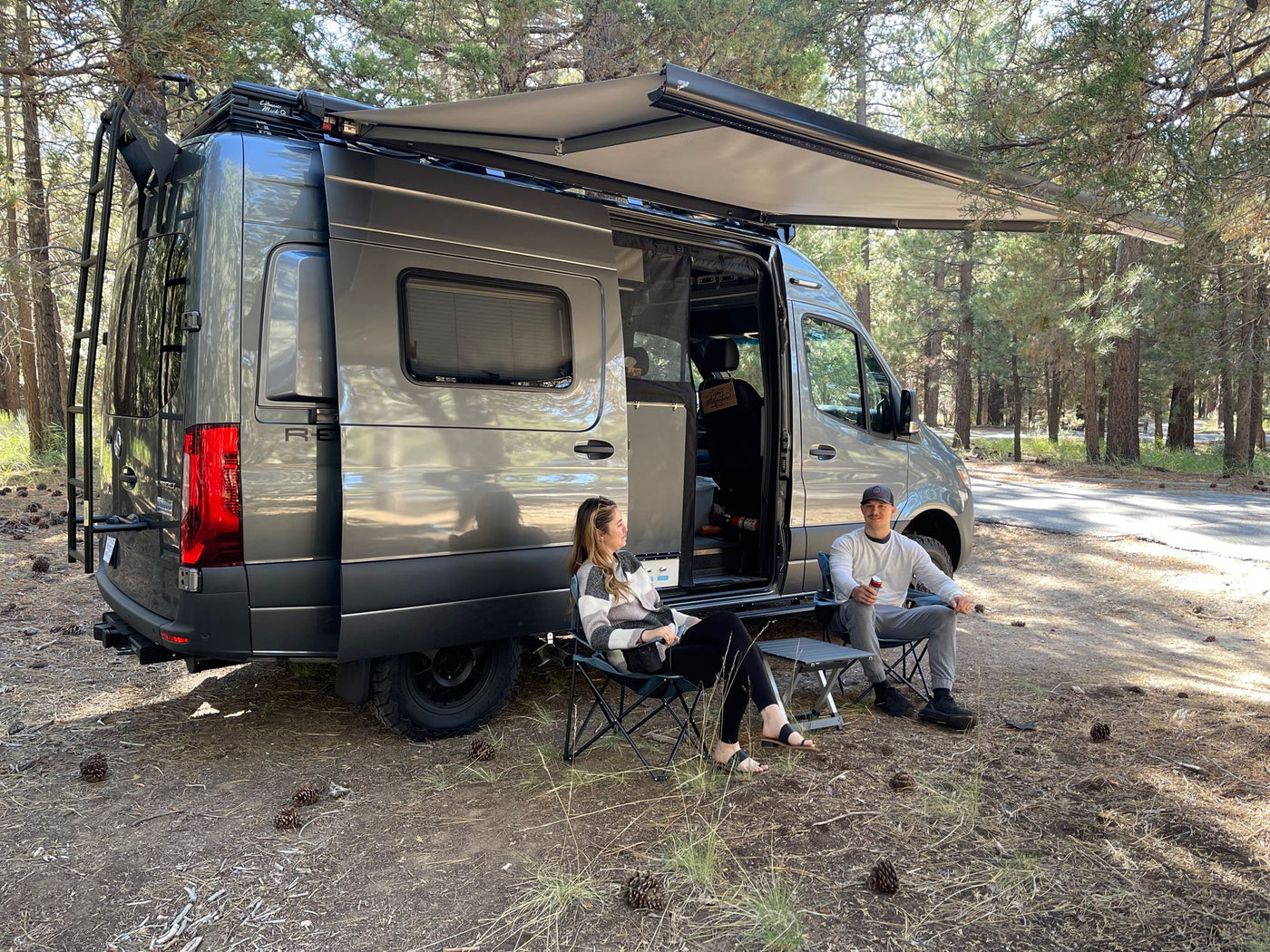  surrounded by stunning red rock formations & mountains under a clear sky. Ideal for adventure travel.|Relaxing by an RV rental in the forest