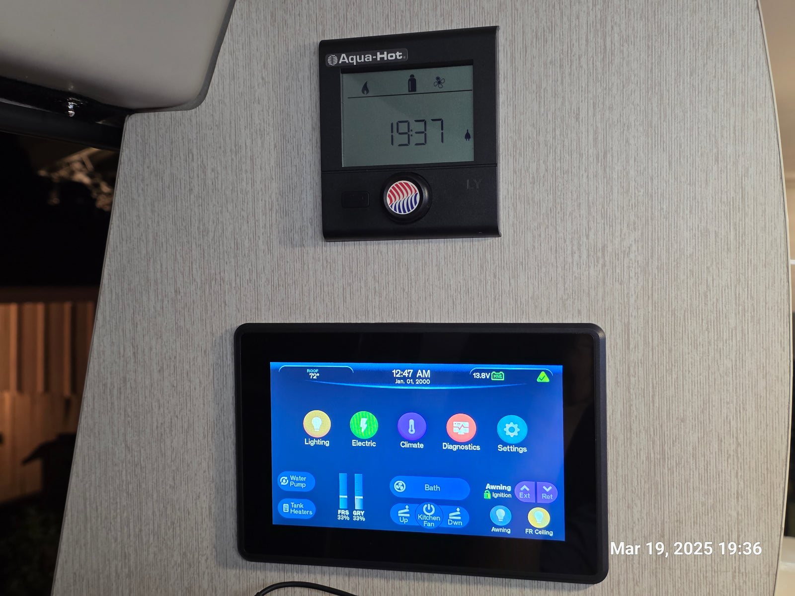 RV rental: Interior shot of Aqua-Hot and smart control panels managing climate, lighting, tank levels, and awning.