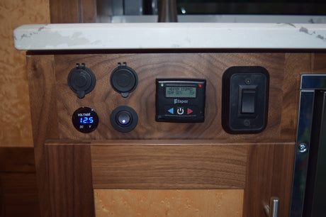 RV rental control panel. Features include a 12.5V meter, USB/12V charging ports, an Espar heater thermostat (71F), and system switches.