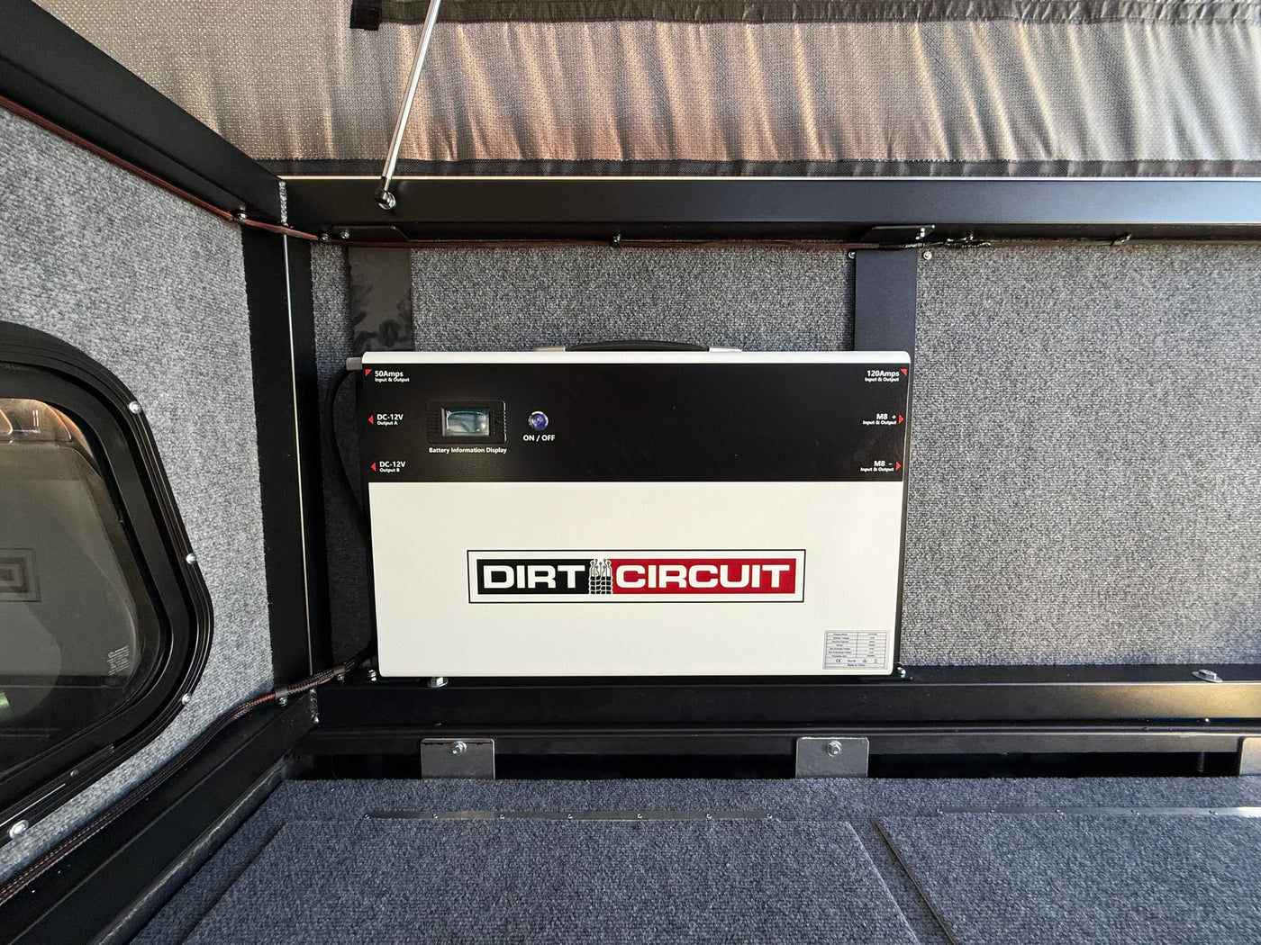 View inside an **rv rental**, featuring a DIRT CIRCUIT power management system with battery display for off-grid use. — photo 9