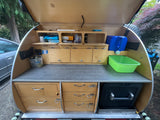 Open teardrop trailer galley. A compact, organized outdoor kitchen perfect for an rv rental or camping trip.