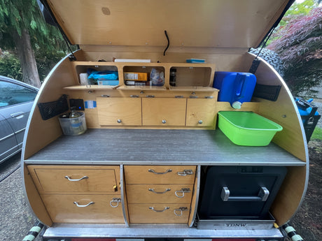 Open teardrop trailer galley. A compact, organized outdoor kitchen perfect for an rv rental or camping trip.