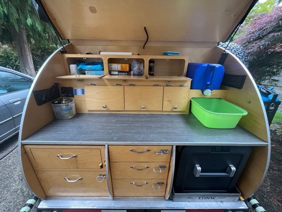 Open teardrop trailer galley. A compact, organized outdoor kitchen perfect for an rv rental or camping trip.
