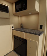 Compact RV rental kitchen with microwave, sink, granite-like counter, & under-counter fridge. Functional travel space.