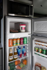 RV rental kitchen: microwave, fridge with Baskin Robbins, Modelo, Fiji, Bubly, eggs, and fresh produce.