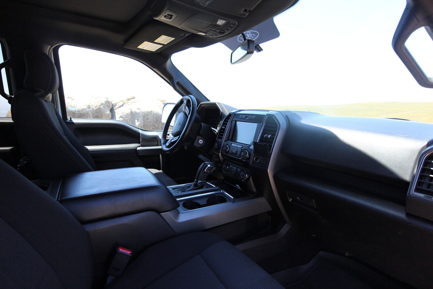Modern truck interior with black seats, console, & dashboard. Perfect for a comfortable RV rental journey. — photo 13